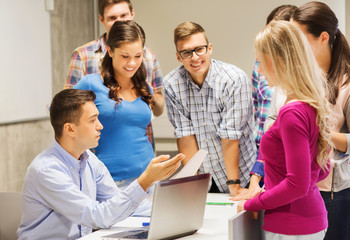 group of students and teacher with laptop