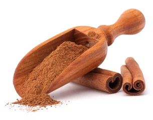 Photo sur Aluminium Herbes ground cinnamon spice powder in wooden spoon isolated on white b