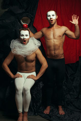 Hocus pocus concept. Two mime artists, clowns make prestige