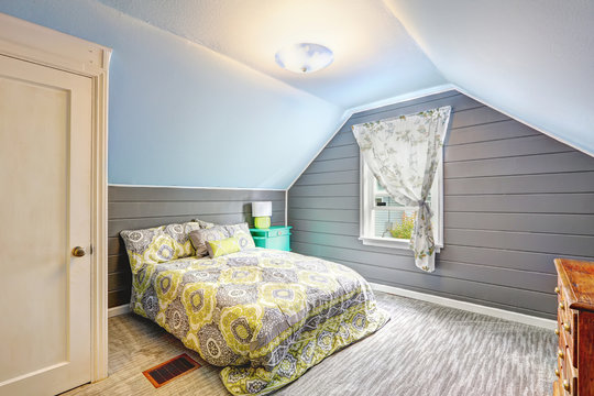 Bedroom with vaulted ceiling and plank paneled walls