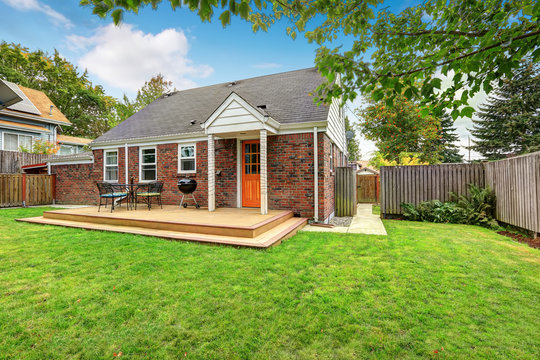 Brick house exterior with walkout wooden deck