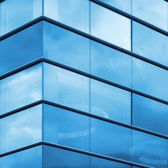 Modern office facade fragment, blue glass and steel frames