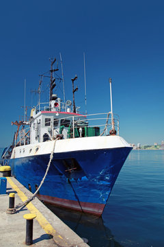 Blue fishing boat is moored on the coast of Black Sea, Bulgaria
