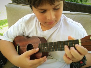 boy playing ukulele