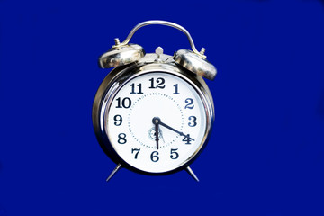 Retro clock on blue background