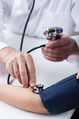 Doctor's hands measuring blood pressure