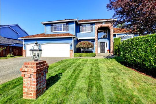 Light Blue House Exterior With Brick Trim And Tile Roof