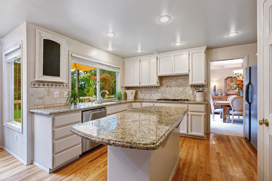 Kitchen room with white storage combination and island