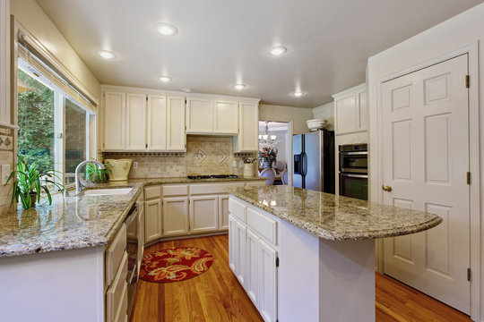Kitchen room with white storage combination and island