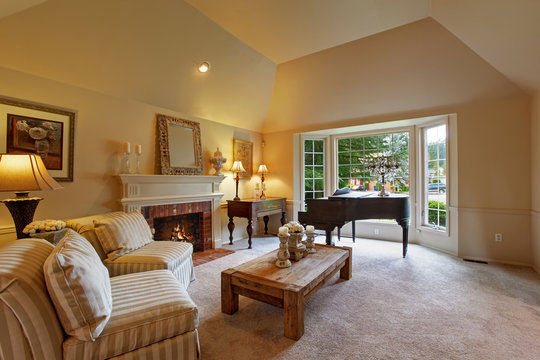 Luxury family room with grand piano and fireplace