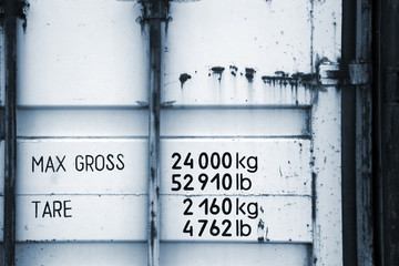 Cargo container fragment with weight marks. Monochrome photo