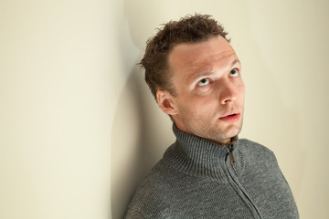 Closeup portrait of young thinking Caucasian man