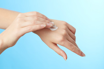 Woman's hands in moisturizer cream