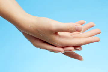 Woman's hands in moisturizer cream