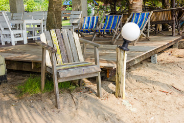 Fototapeta na wymiar Wooden chairs on the beach