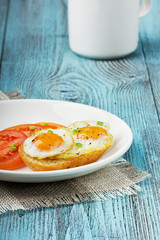 Quail eggs with a toast and tomatoes strewed