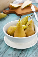 Naklejka na ściany i meble Pears on a wooden background