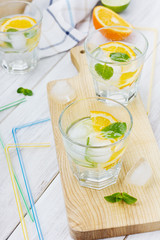 Water with limes, oranges, lemons, ice and mint