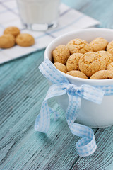 Cookies with blue ribbon and milk