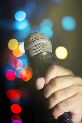 Microphone in human hand.