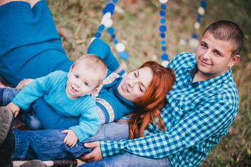 Fototapeta na wymiar Happy family have birthday party with blue decorations in forest