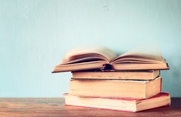 Old books on a wooden table. retro filtered image