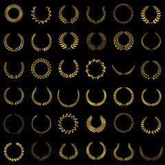 Set of gold award laurel wreaths and branches on dark background