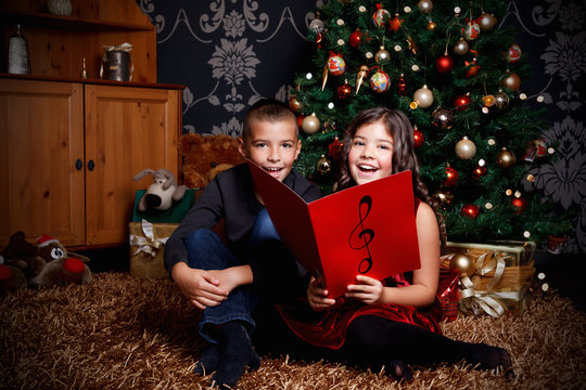 Little Children Singing A Song At Christmas Eve