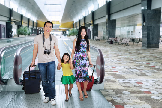 Family walking in the airport hall