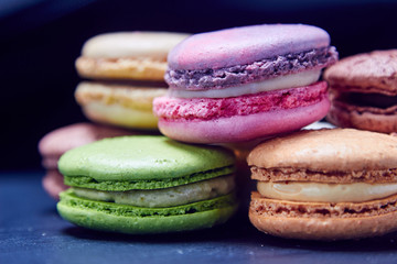 Luxury macaroons on black slate, front view
