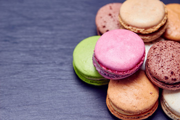 Macaroons in different colours and black background