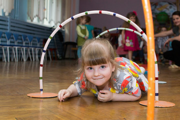 Beautiful girl takes part in relay competition in kindergarten