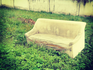 Old broken sofa with retro filter effect