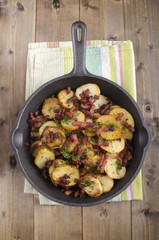 fried organic potatoes with fat bacon