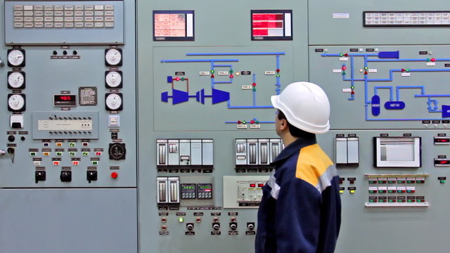 engineer checks light indication on main panel of station