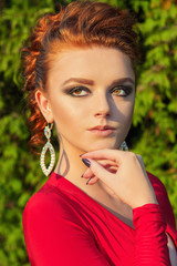 Obraz premium beautiful elegant girl with makeup in a red evening dress