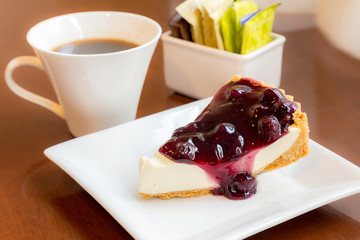 Bluberry pie with coffee on woodern table