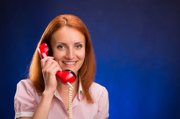 Redhead girl with red telephone