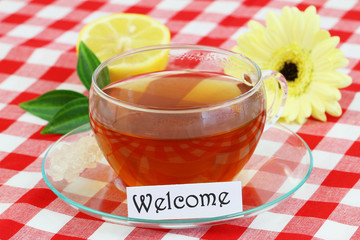 Welcome card with cup of tea, lemon and gerbera daisy