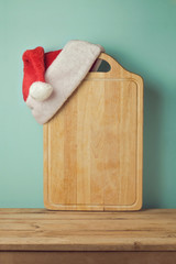 Christmas background with cutting board and Santa hat