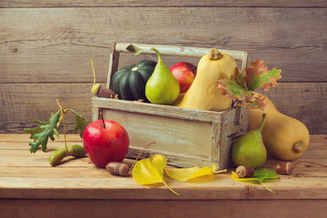 Autumn fruits and pumpkin on wooden table. Thanksgiving dinner