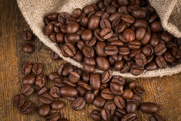 Coffee beans on grunge wooden background