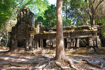 Naklejka premium The ancient ruins of a historic Khmer temple in the temple compl