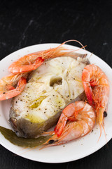boiled fish with boiled shrimps on plate