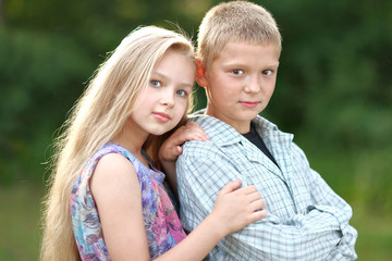Obraz premium Portrait of a boy and girl in summer