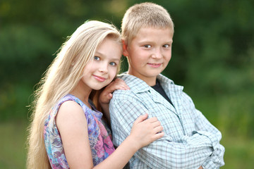 Fototapeta premium Portrait of a boy and girl in summer