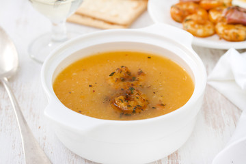 soup with seafood in white bowl