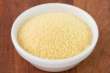 couscous in white bowl on dark background
