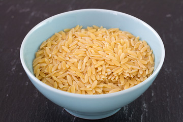 pasta in blue dish in black background