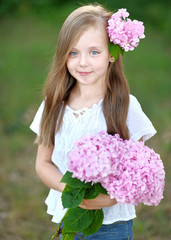 portrait of little girl with flowers hydrangea